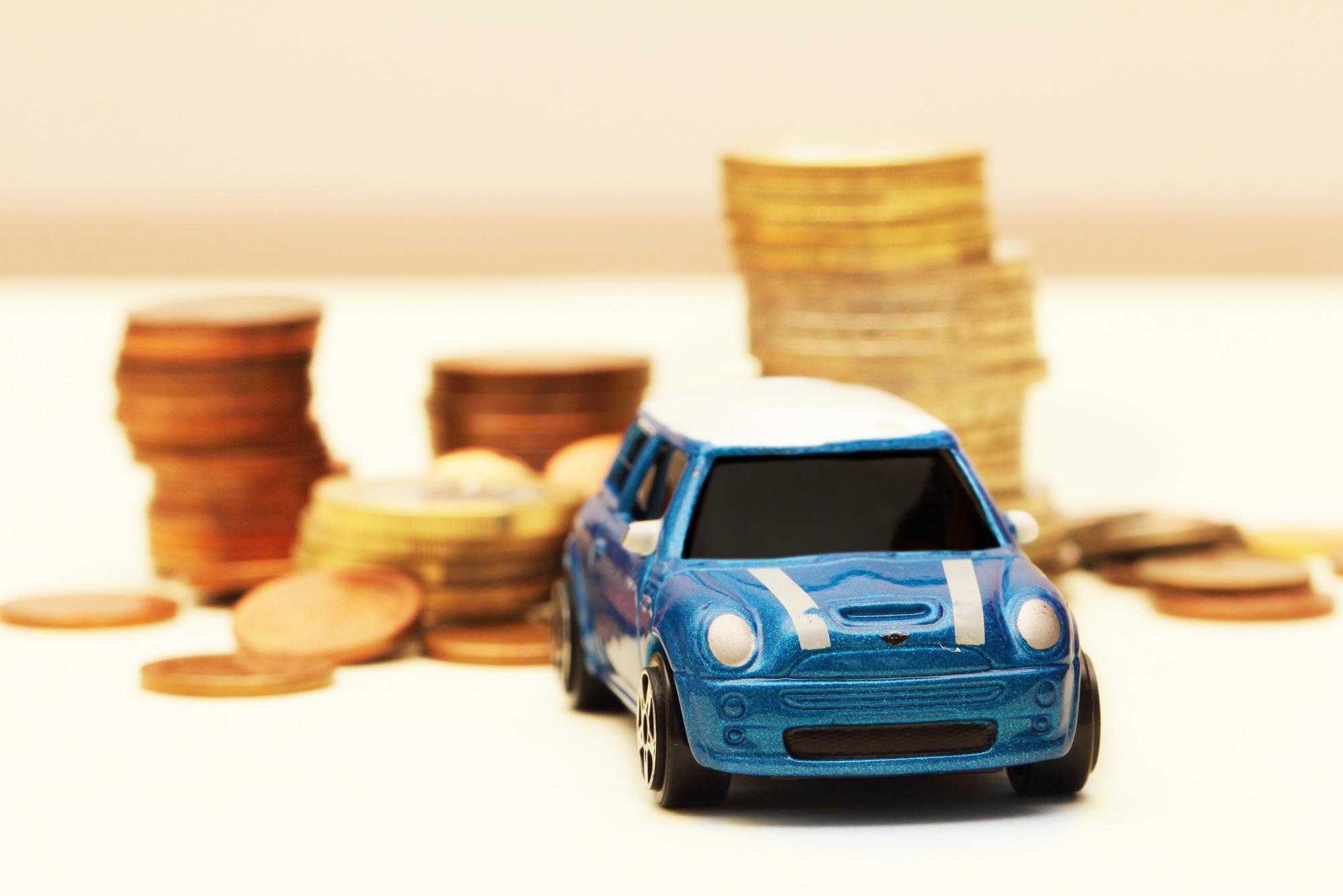 stacked coins and toy car