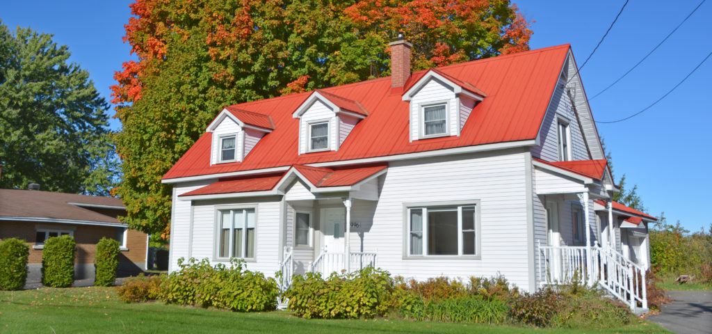 white house with red roof - Lomonte & Collings